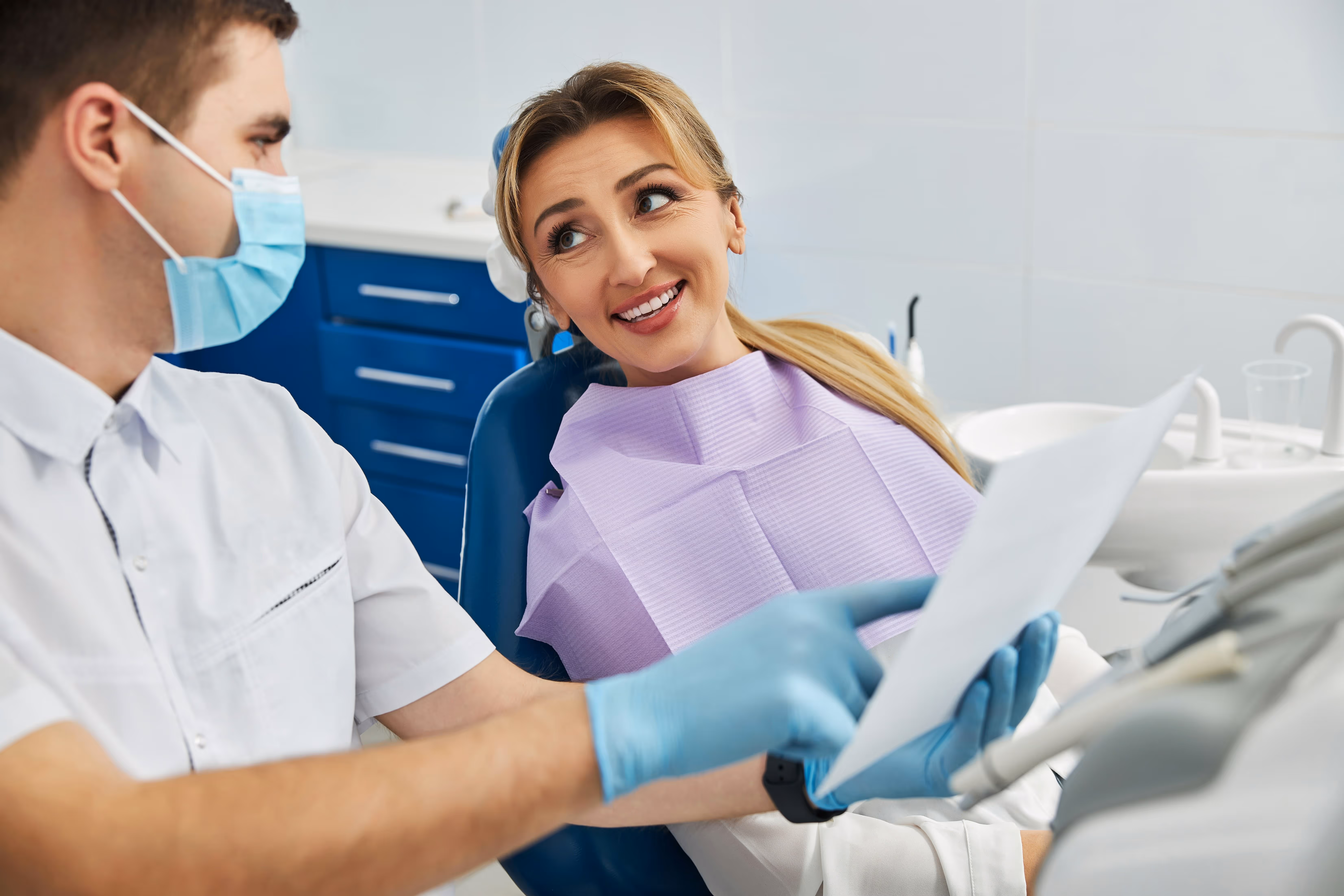 Dental Patient with a smile talking with Dentist